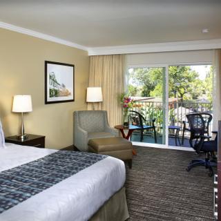 Best Western Plus Garden Court Inn | Fremont, California | King bedroom with couch and patio